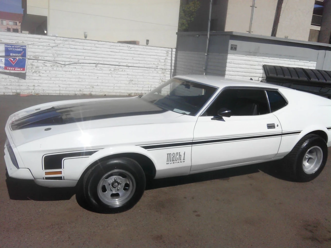 White Ford Mustang Mach 1 parked after service