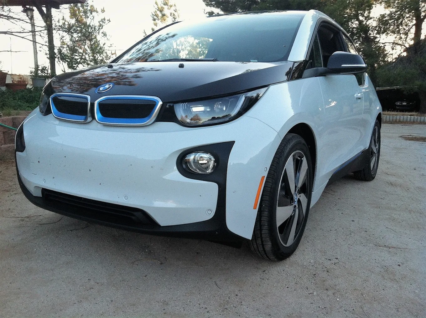 White BMW i3 parked in a driveway after a visit